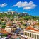 The ancient Acropolis standing on a hill above the modern city of Athens, Greece